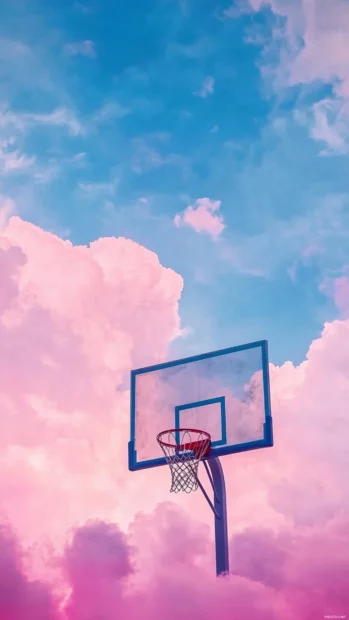 Silhouetted basketball hoop against a cotton candy aesthetic sky.