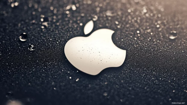 Simple white Apple logo on clean black surface, ultra minimal design.