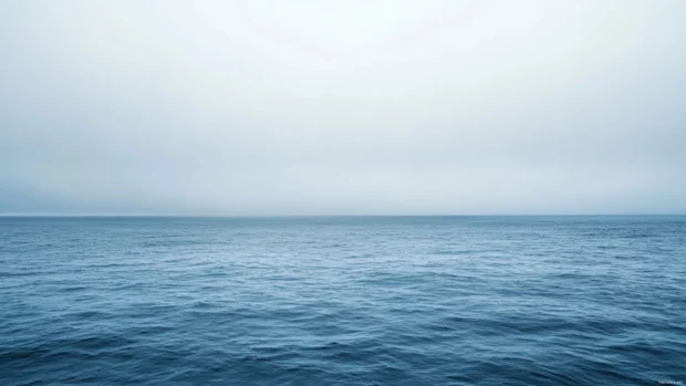 Smooth ocean horizon line viewed from a sailing boat deck.