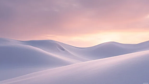 Snow covered landscape glowing under the soft light of a winter sunset.
