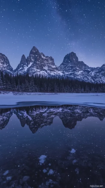 Snowy peaks crowned with glowing star belts, embracing the wonder of midnight starry heavens wallpaper.
