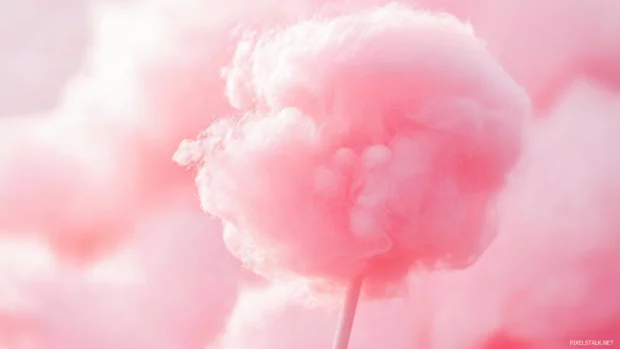 Soft pink cotton candy clouds at sunset with a dreamy glow.