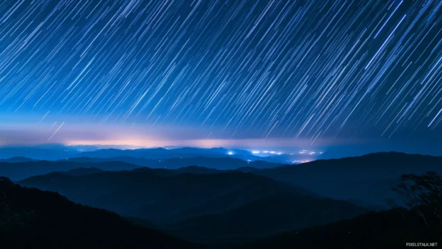 Stars cascading over silent snowy valleys.