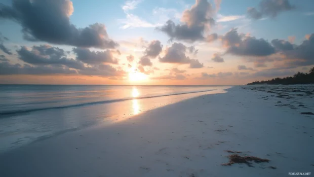 Sunset over a serene beach with soft clouds, a classic HD desktop wallpaper look.