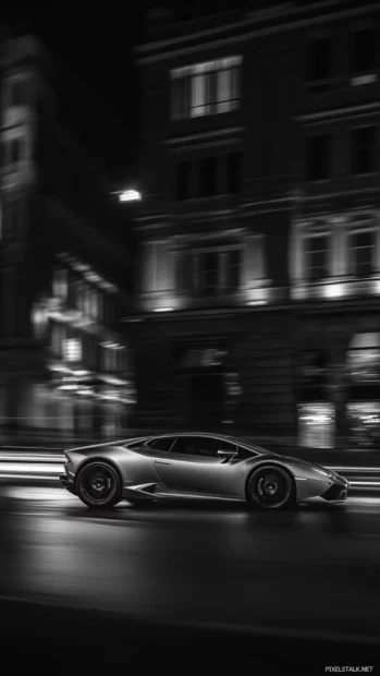 Vertical Lamborghini Huracan HD wallpaper of a silver Huracan speeding past streetlights at night.