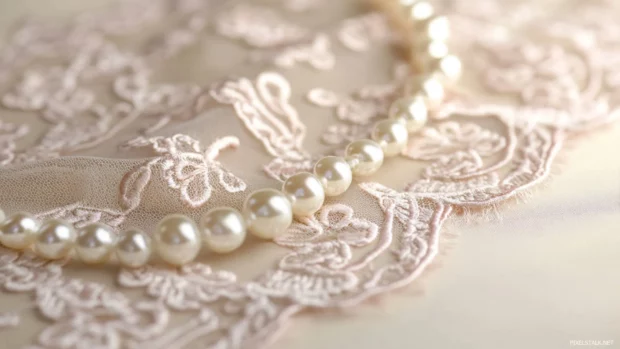 Vintage inspired pink lace and pearls arranged on a romantic setting.