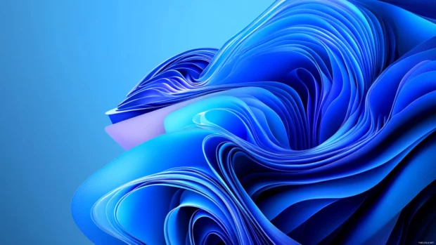 Windows 11 abstract desktop wallpaper with layered light effects.