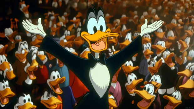 With arms stretched wide, Daffy Duck shouts in the middle of a crowded cartoon set.