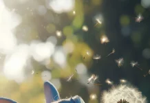 3D Stitch blowing on a dandelion with fine particles floating realistically.