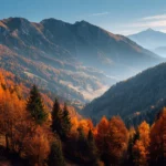 4k autumn trees wallpaper panoramic vista of mountain ridge lined by fiery autumn trees under crystal blue sky.