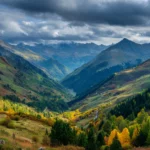 4k fall landscape wallpaper illustrating panoramic mountain valleys bursting in autumn colors under dramatic clouds.