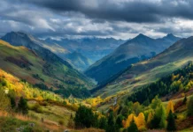 4k fall landscape wallpaper illustrating panoramic mountain valleys bursting in autumn colors under dramatic clouds.