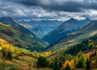 4k fall landscape wallpaper illustrating panoramic mountain valleys bursting in autumn colors under dramatic clouds.