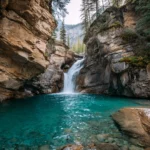 4k waterfall wallpaper showcasing a wide curtain of water spilling from rocky cliff into turquoise basin.