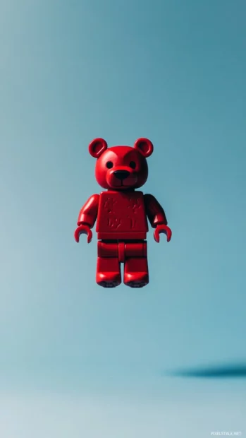 A Bearbrick toy floating in the center of a solid color background.
