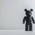 A Bearbrick wallpaper featuring a classic Bearbrick figure standing alone on a white minimalist background.