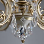 A beautiful Luxury chandelier made of gold and silver metals with delicate hanging crystals.