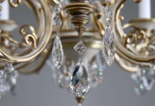 A beautiful Luxury chandelier made of gold and silver metals with delicate hanging crystals.