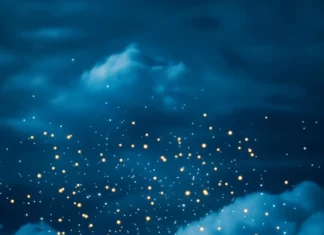 A book illuminated under fairy lights surrounded by gentle clouds.