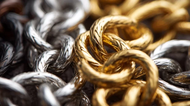 A close up of Luxury metal chains with bold links in gold and silver intertwined.