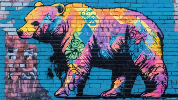A graffiti bear wallpaper featuring a cool bear with vibrant spray paint patterns on a brick wall background.