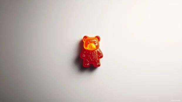 A gummy bear wallpaper featuring a single gummy bear centered on a white minimalist background.