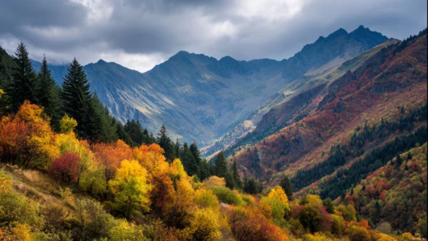 A majestic mountain landscape with fall trees spreading vibrant colors across the hills.