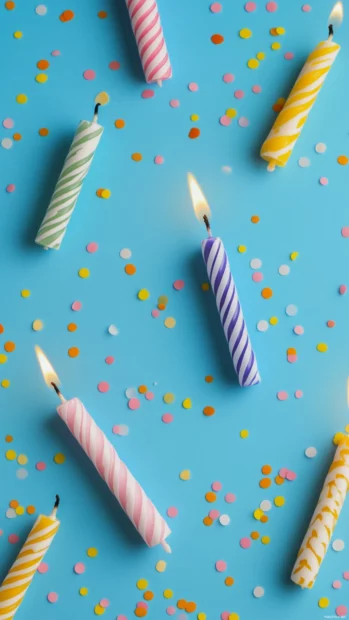 Aesthetic composition of birthday candles lying on a clean surface.