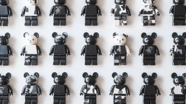 Bearbrick pattern wallpaper displaying multiple Bearbricks in various poses on a white background.