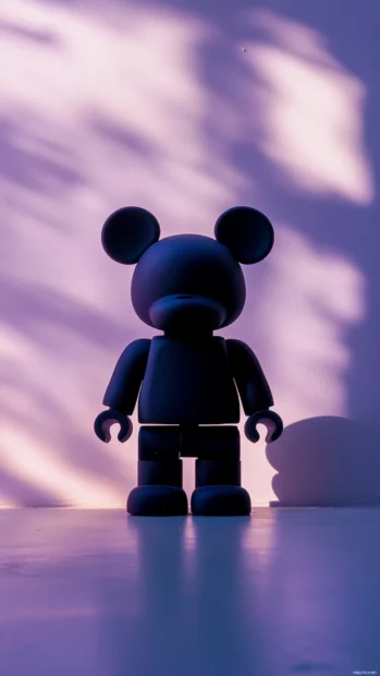 Bearbrick silhouette cast in front of pale lavender wall.