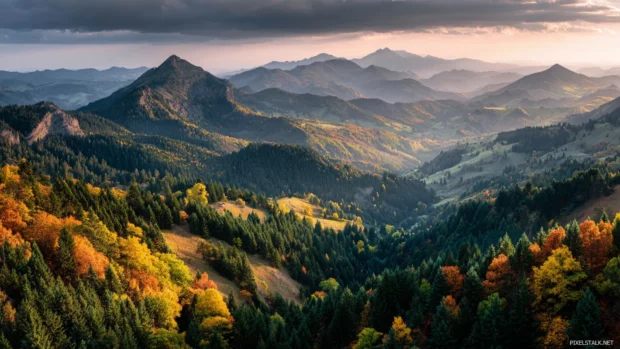 Beautiful fall wallpaper depicting panoramic vista of layered mountains and forests ignited in peak autumn colors.
