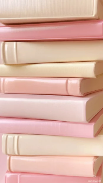 Book design with pink and cream hardcover books stacked in pastel tones.