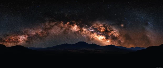 Breathtaking view of the Milky Way blending into mountain silhouettes, perfect for 3440x1440 wallpaper.
