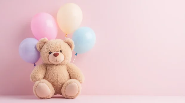 Cute teddy bear wallpaper showcasing a chubby teddy bear with pastel balloons against a plain pink backdrop.