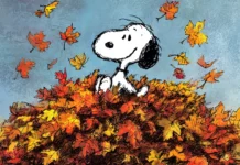 Fall afternoon with Snoopy joyfully playing in a pile of colorful autumn leaves.