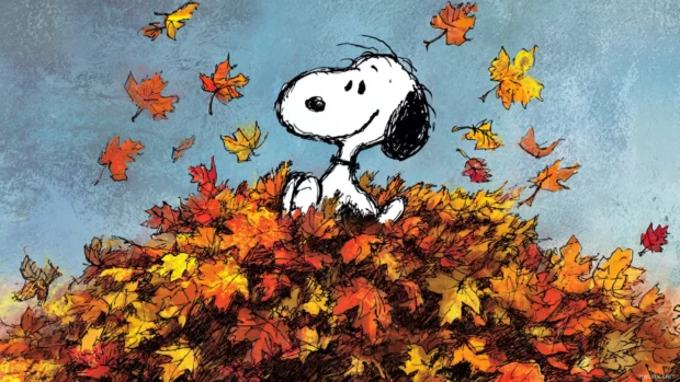 Fall afternoon with Snoopy joyfully playing in a pile of colorful autumn leaves.