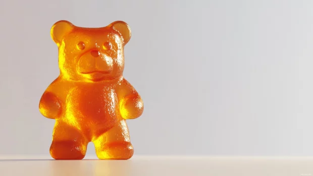 Gummy bear wallpaper capturing a high resolution image of a gummy bear on a plain white backdrop.