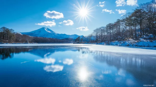 Japans snow capped peaks shimmering under a bright winter sun reflecting on frozen lakes.