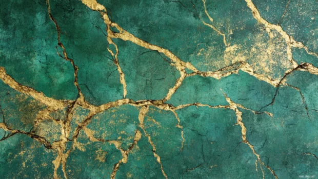 Luxury metallic wallcovering showing distressed gold leaf veins over dark emerald backdrop for richest statement.