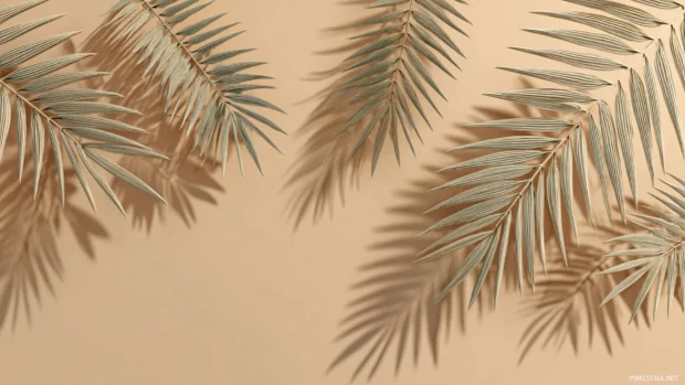 Palm leaves background scene portraying scattered palm fronds with gentle shadows on smooth tan surface.