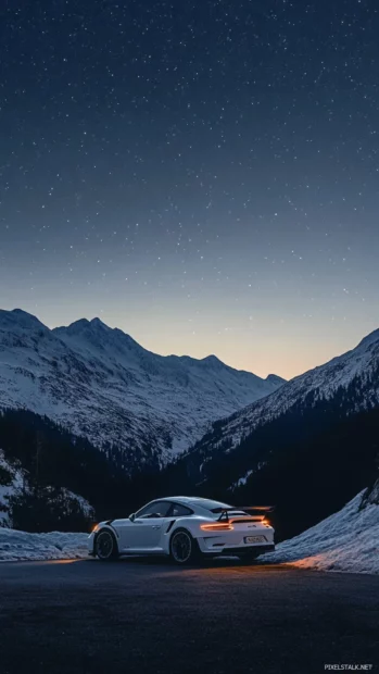 Porsche 911 gt3 rs framed against a stunning mountain backdrop under a clear starry sky.