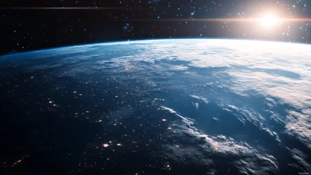 Space Earth wallpaper with dramatic lighting casting shadows across the planets surface.