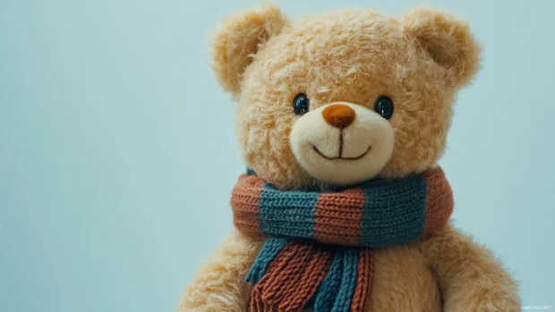 Teddy Bear wearing a scarf with a white soft background.
