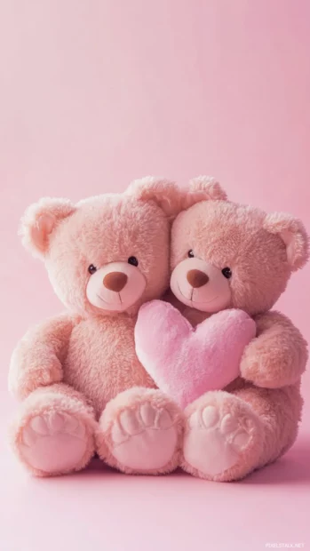 Teddy bear love wallpaper showing a hugging teddy bear couple on a smooth pastel pink background.
