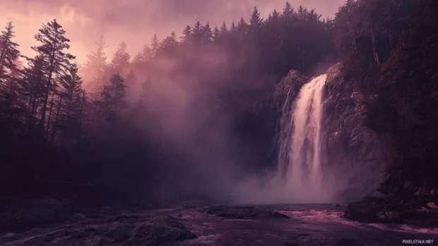 Waterfall wallpaper featuring a towering cascade plunging into a misty forest pool at dawn under soft light.