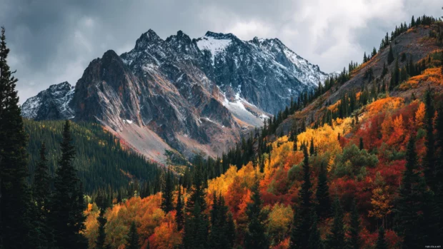 4K fall scenery wallpapers presenting a majestic mountain range surrounded by breathtaking fall colors.