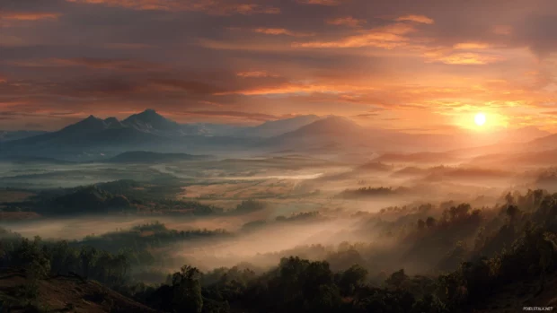 A breathtaking landscape background capturing the essence of sunrise over a misty valley, bringing warmth and inspiration to your screen.