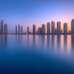 A clean and simple depiction of the Dubai Marina with its iconic skyscrapers and calm waters.