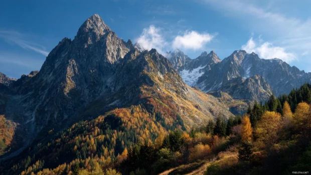 Autumn mountain laptop wallpaper portraying rugged peaks dusted in fall colors under crisp blue sky.