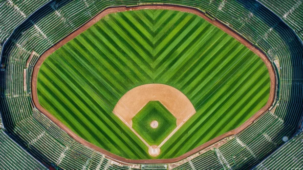 Baseball stadium desktop wallpaper portraying aerial view of full field with symmetrical lines and vibrant green.